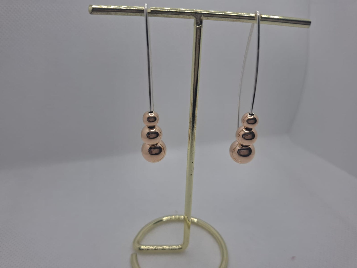 Earring: Drop earrings with Rose gold plated ball details