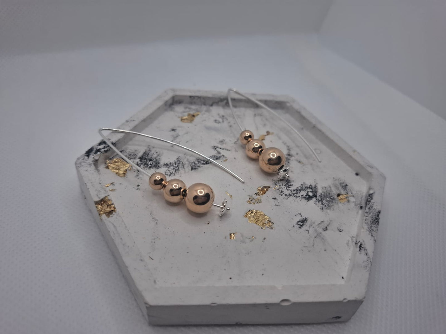 Earring: Drop earrings with Rose gold plated ball details